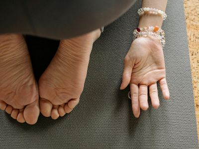 Close-up of a person's feet on a yoga mat.
