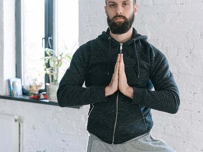 Person in a meditative pose with focused expression.