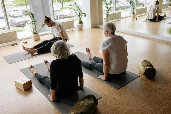 Woman performing a yoga sequence in a bright, modern studio.
